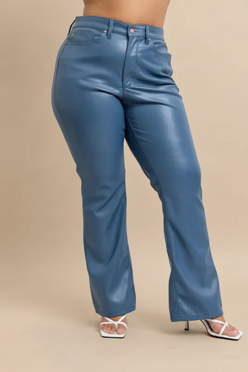 Blue leather pants worn by a person on a plain background