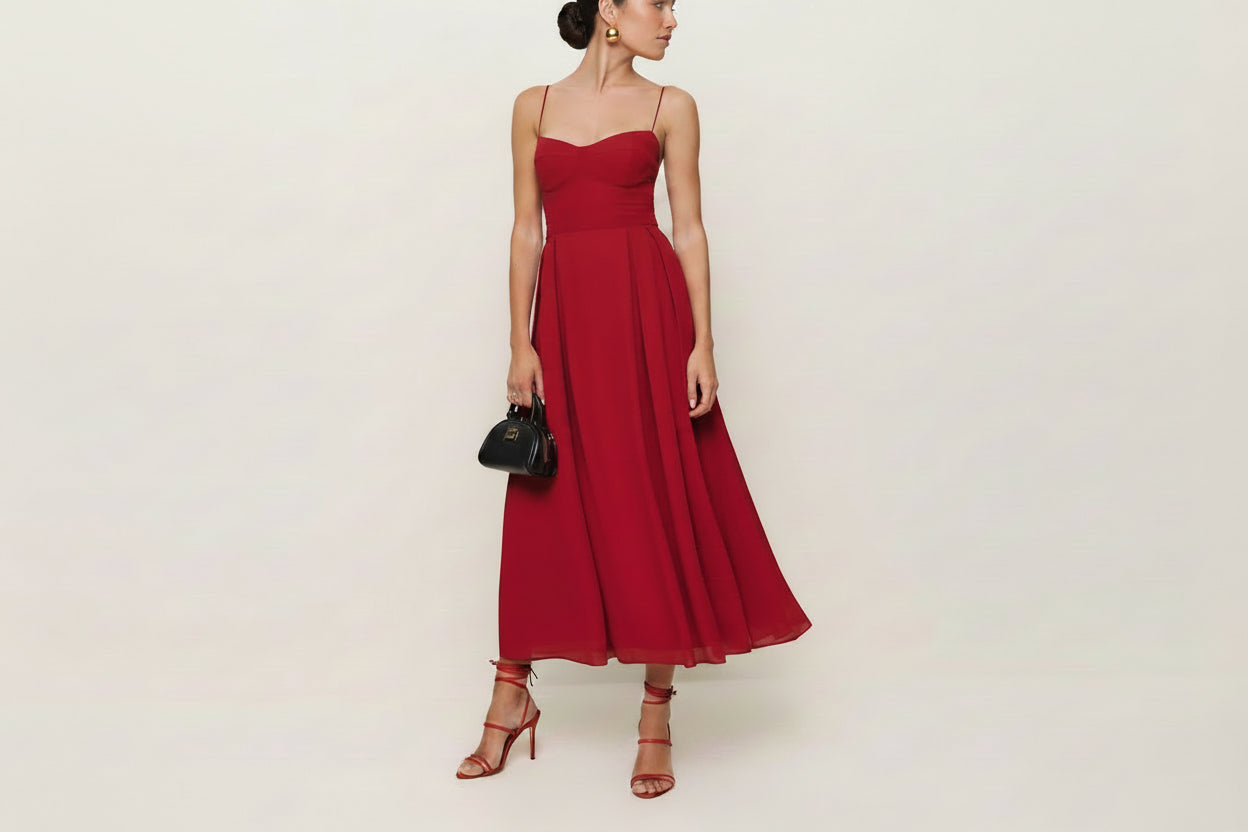 Woman wearing a red dress with a plain background