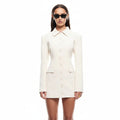 Woman wearing a white blazer dress on a white background