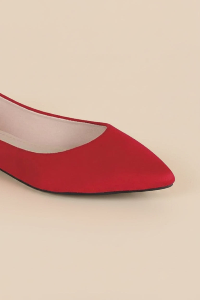 Red pointed-toe shoe on a white background