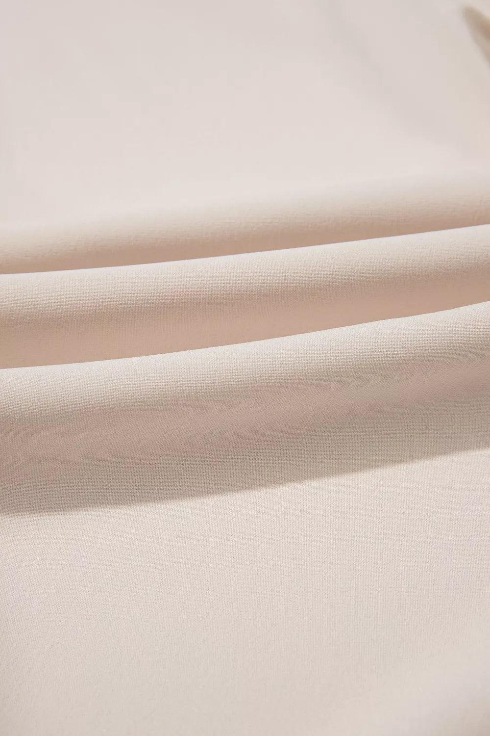 Close-up of beige fabric with a soft texture