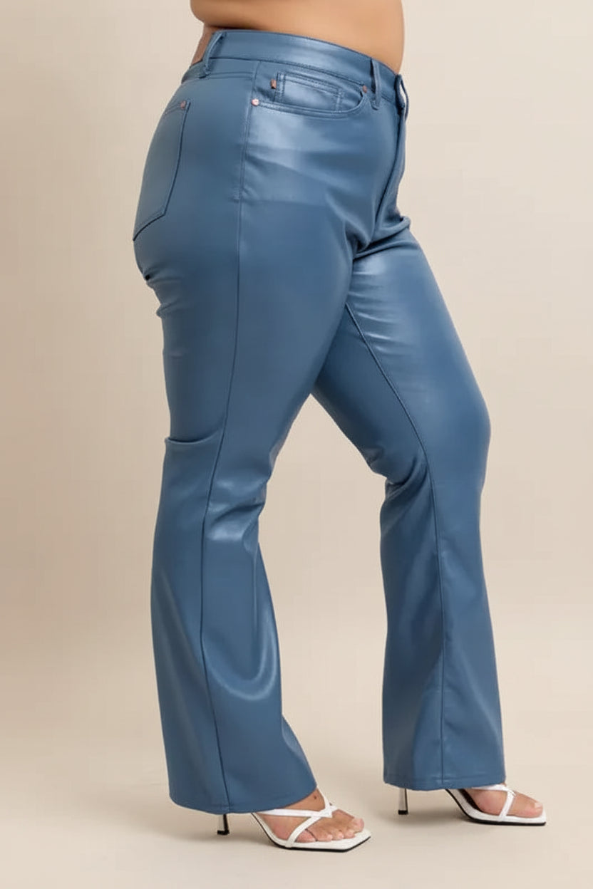 Blue leather pants worn by a person on a plain background