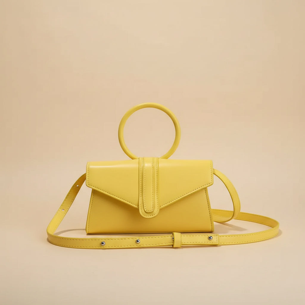 Yellow handbag on a table with a coffee cup in the background