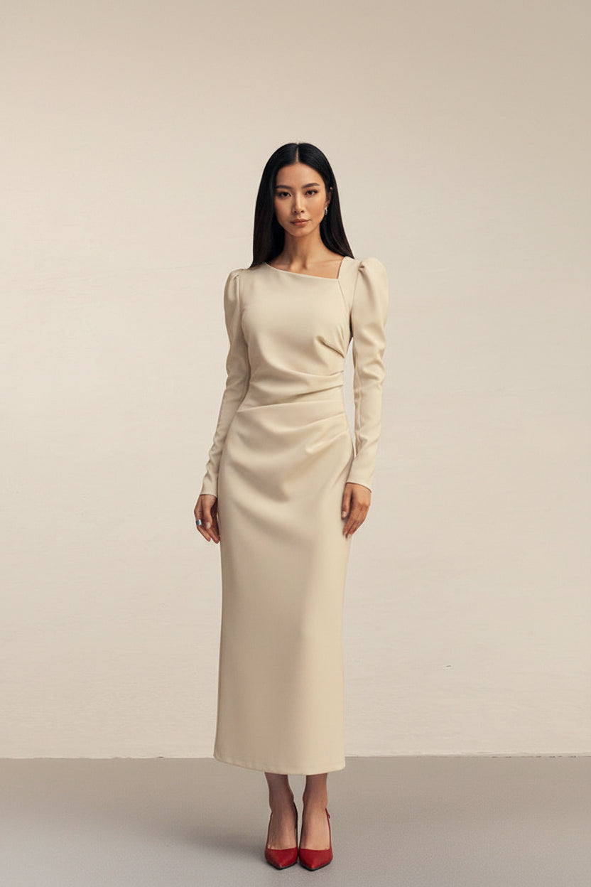 Beige dress with long sleeves and a subtle bow detail on a plain background
