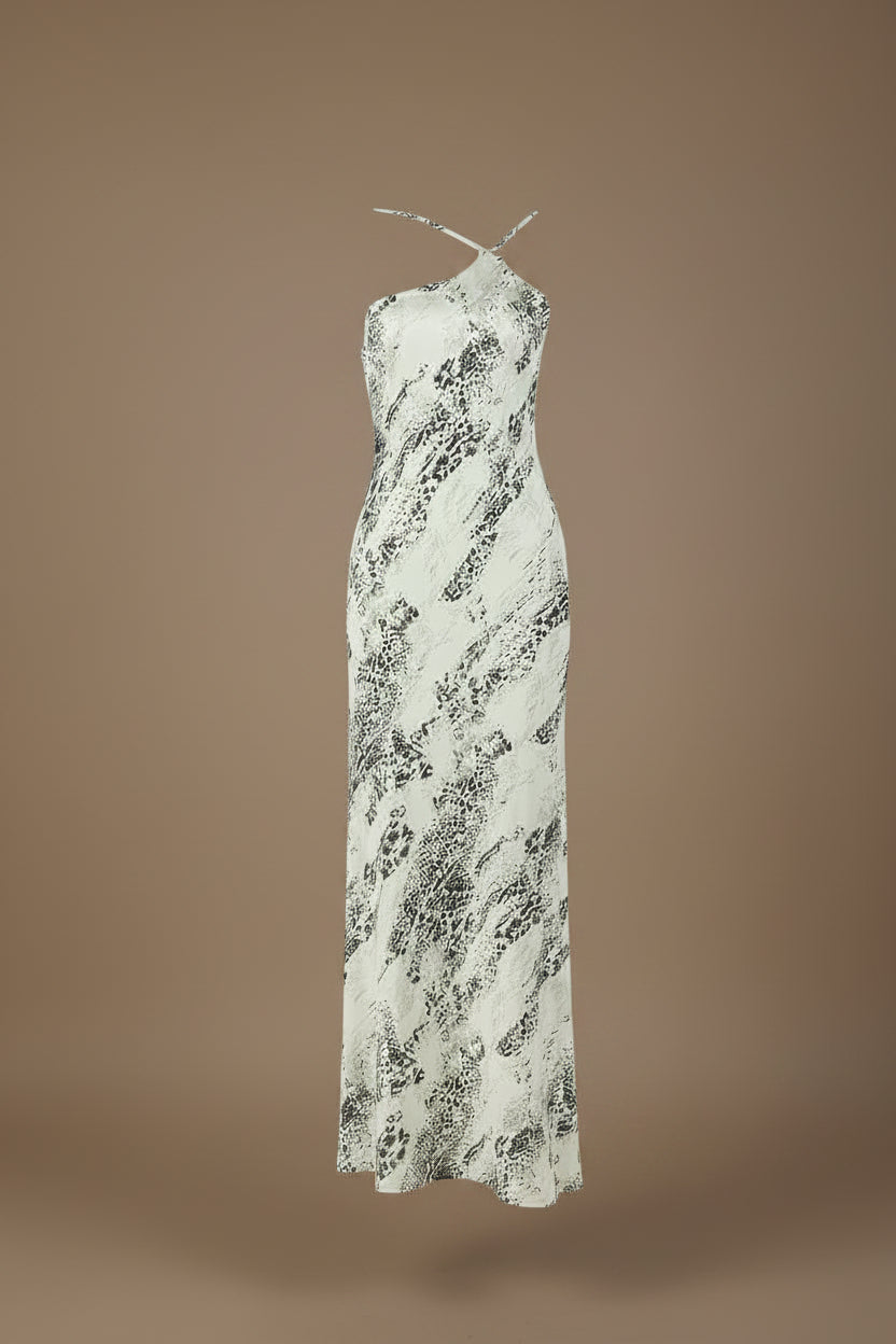 White dress with black pattern on a mannequin against a white background