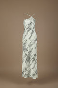 White dress with black pattern on a mannequin against a white background