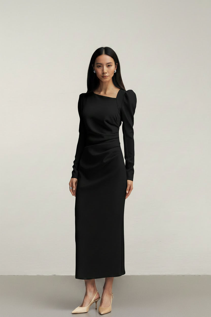 Black dress with puff sleeves worn by a model on a plain background