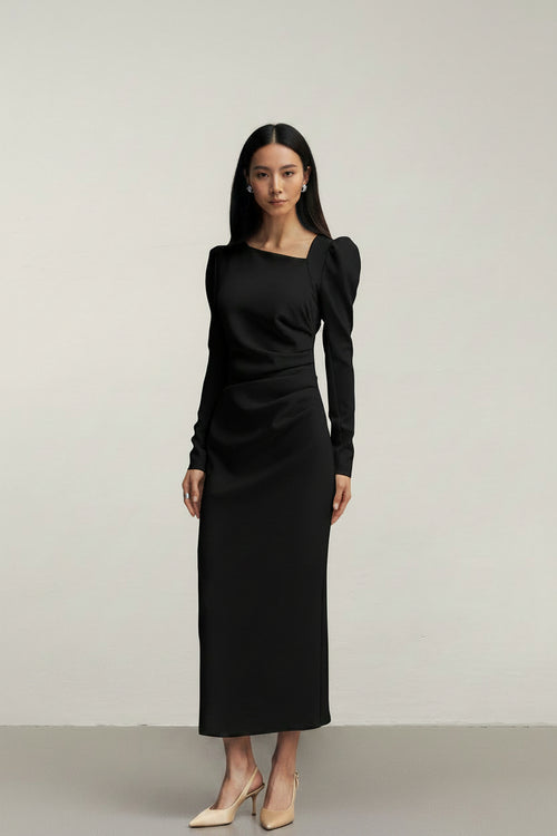 Black dress with puff sleeves worn by a model on a plain background