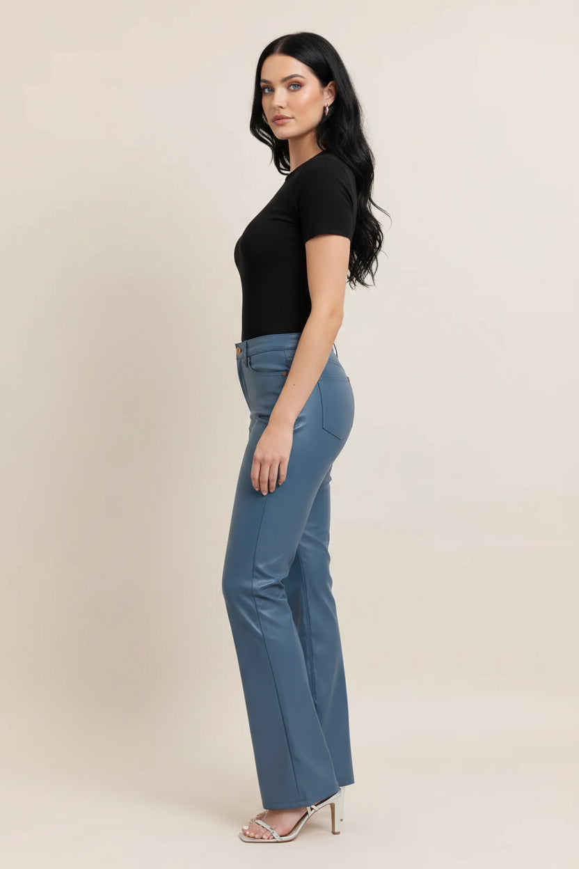 Blue pants worn by a person on a plain background