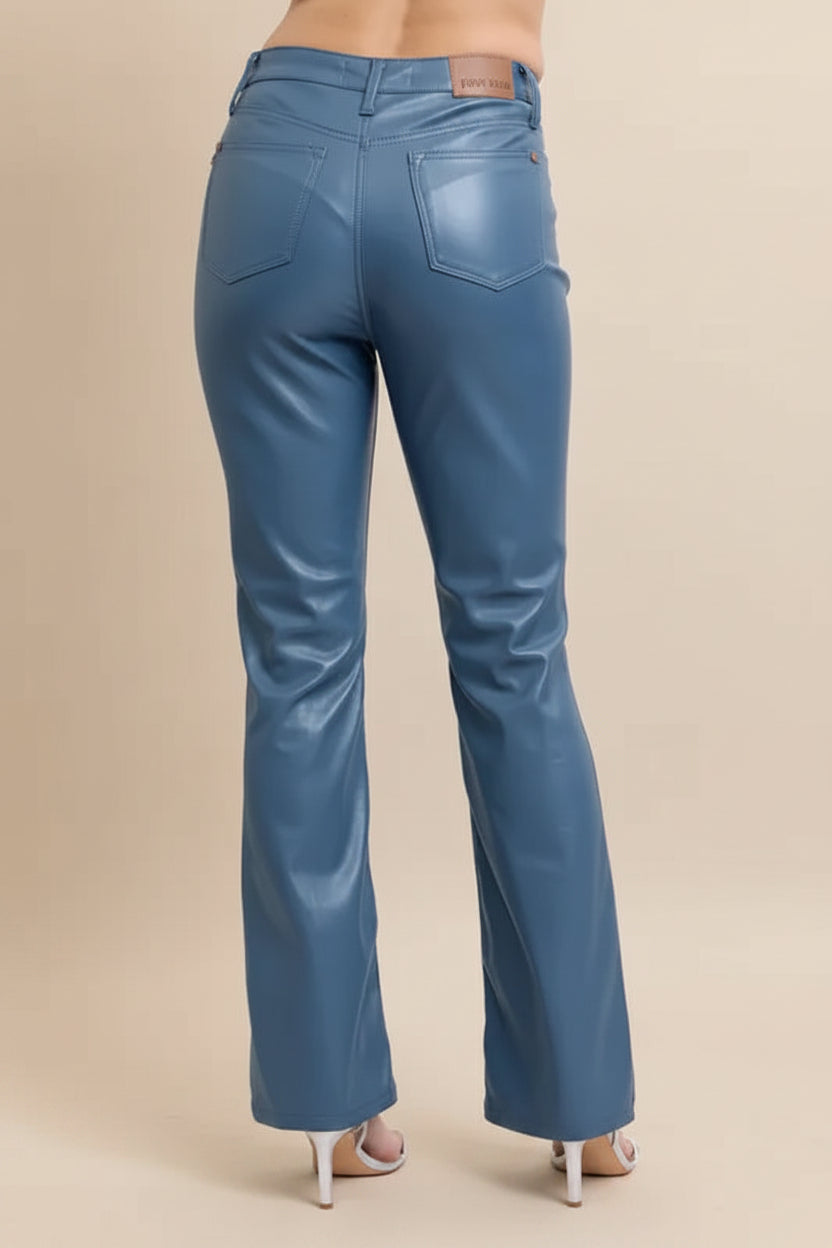 Blue jeans worn by a person on a plain background